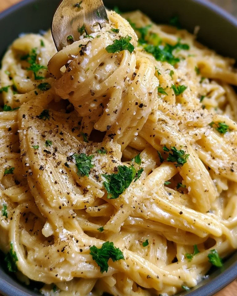 Creamy garlic parmesan pasta dish garnished with herbs and served in a bowl